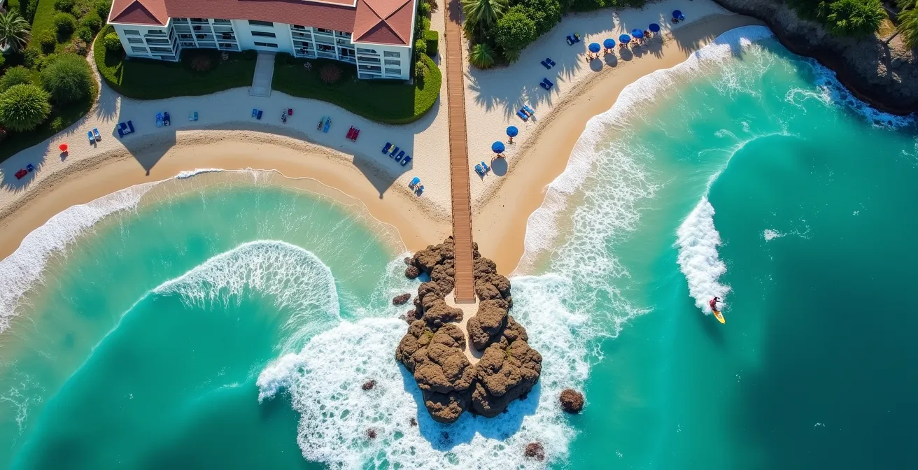 Aerial view of a beachfront resort showing distinct zones for surfing and sunbathing activities